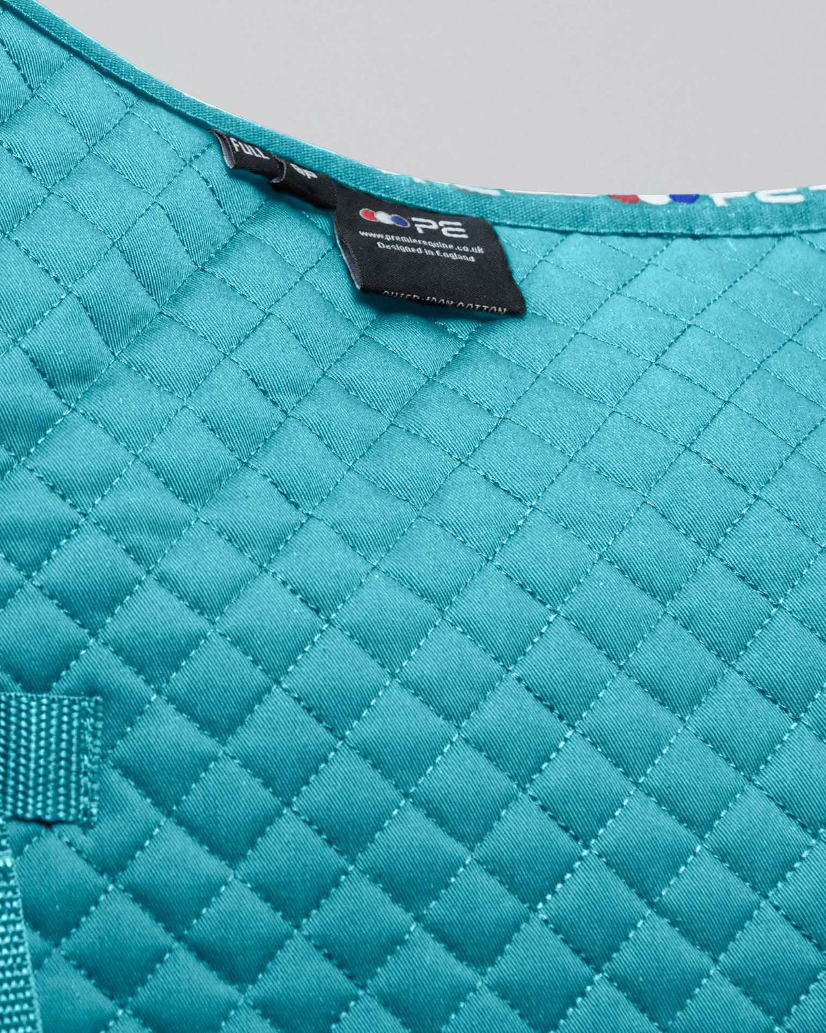 Premier Equine Turquoise Cotton Pony Saddle Pad - Close-up of quilted design and brand label.