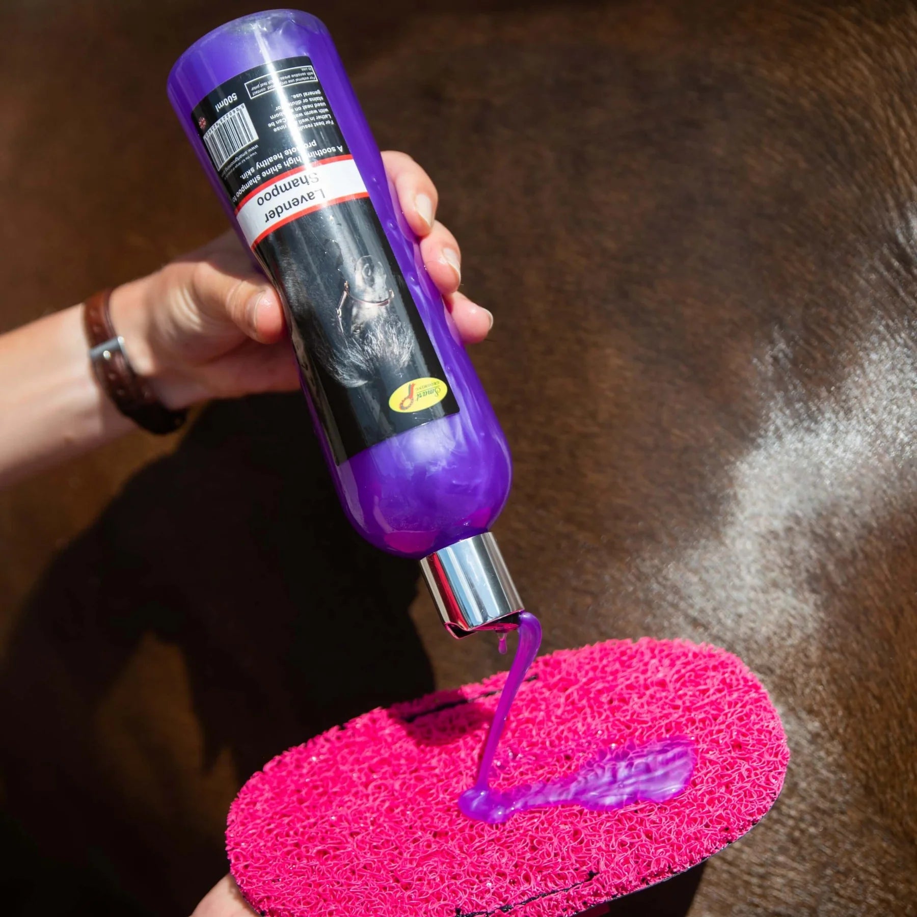 Smart Grooming Lavender Horse Shampoo being poured. Horse grooming product for shiny coat & healthy skin.