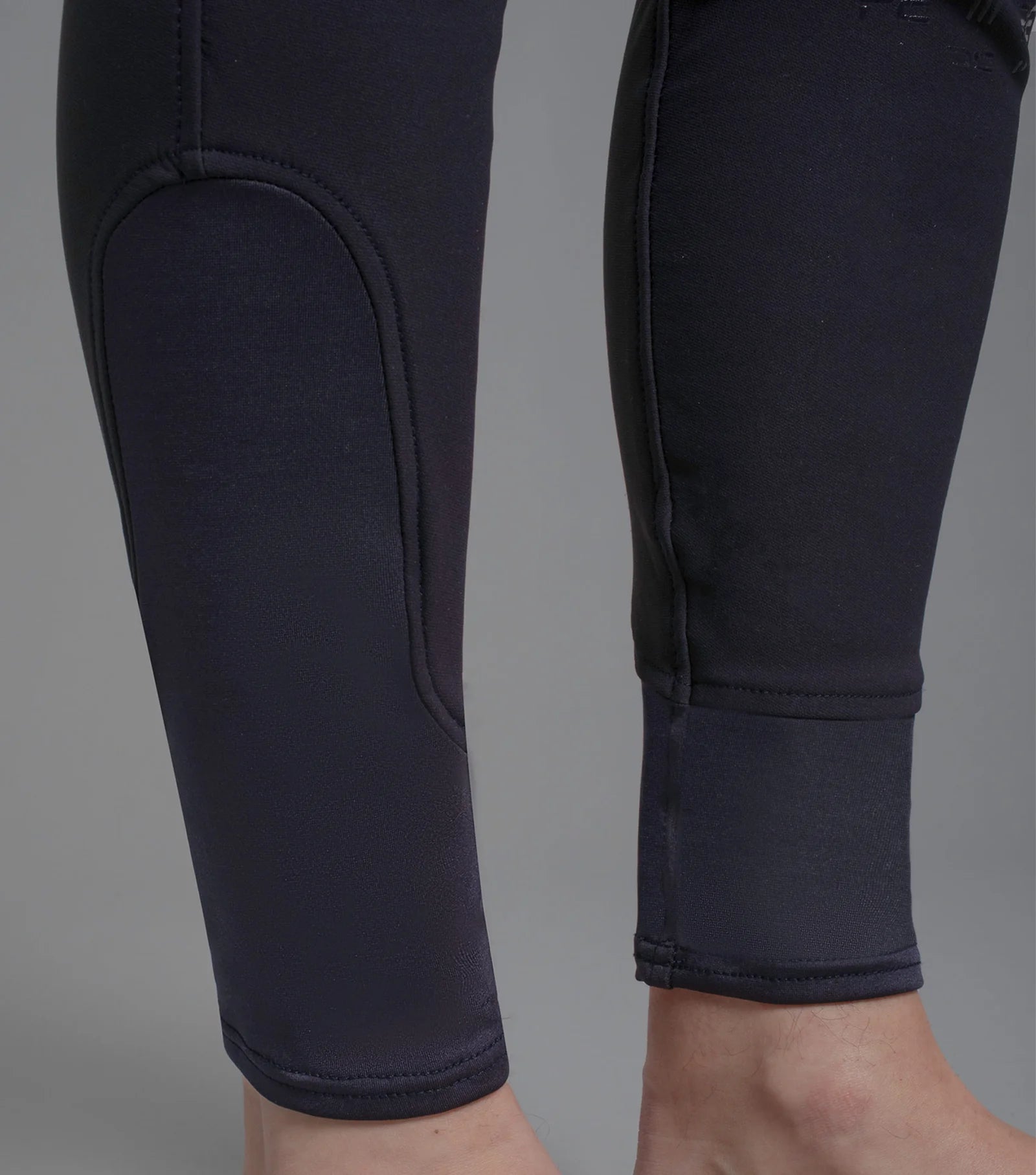 Premier Equine Santino Men's Gel Knee Riding Breeches in Navy - Close up view of the leg area, showing gel patch and ankle cuff.