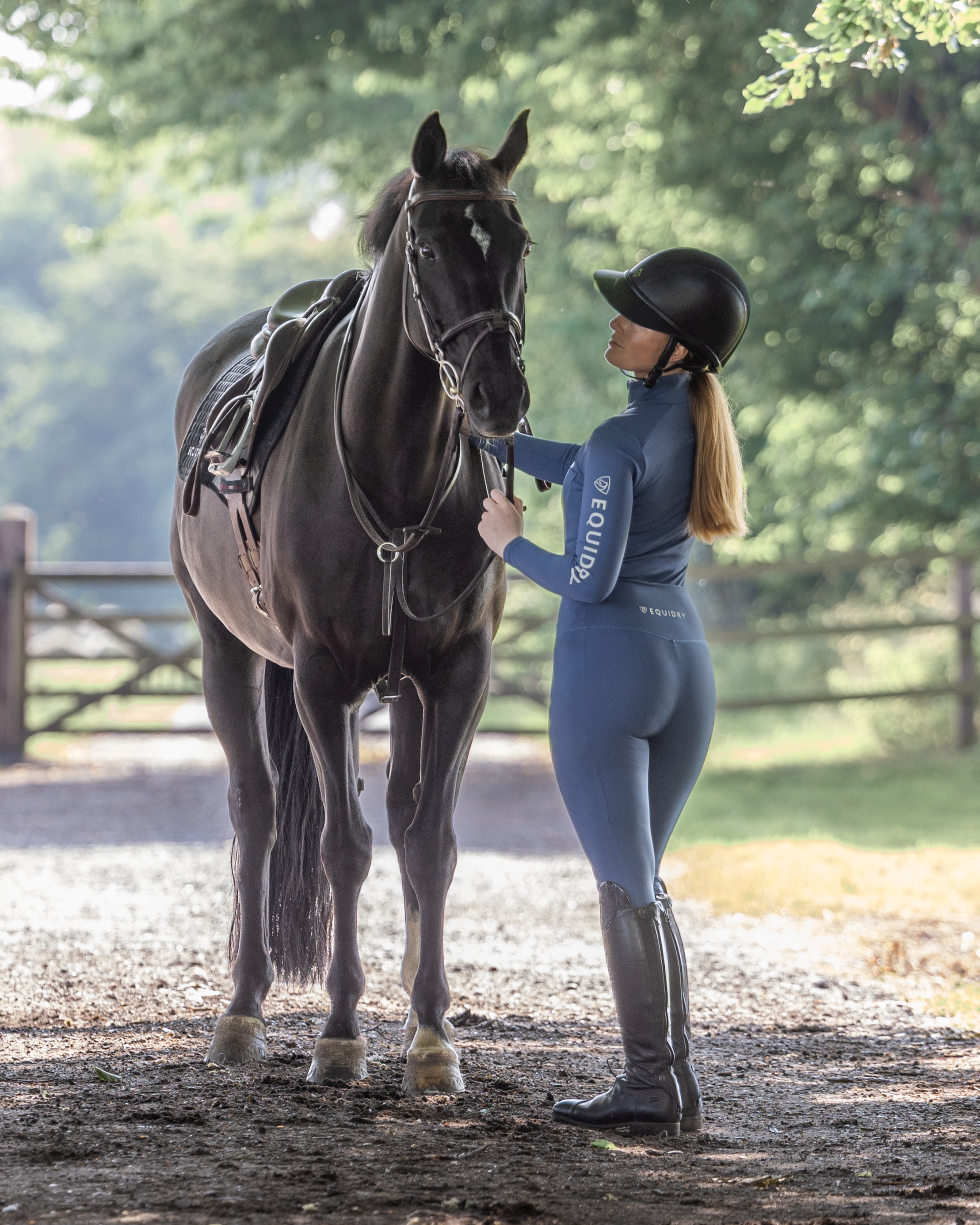 Equestrian with Horse in EQUIDRY Riding Leggings: Water Repellent, Knee Grip, Women's Steel Blue/Grey. Riding Apparel.