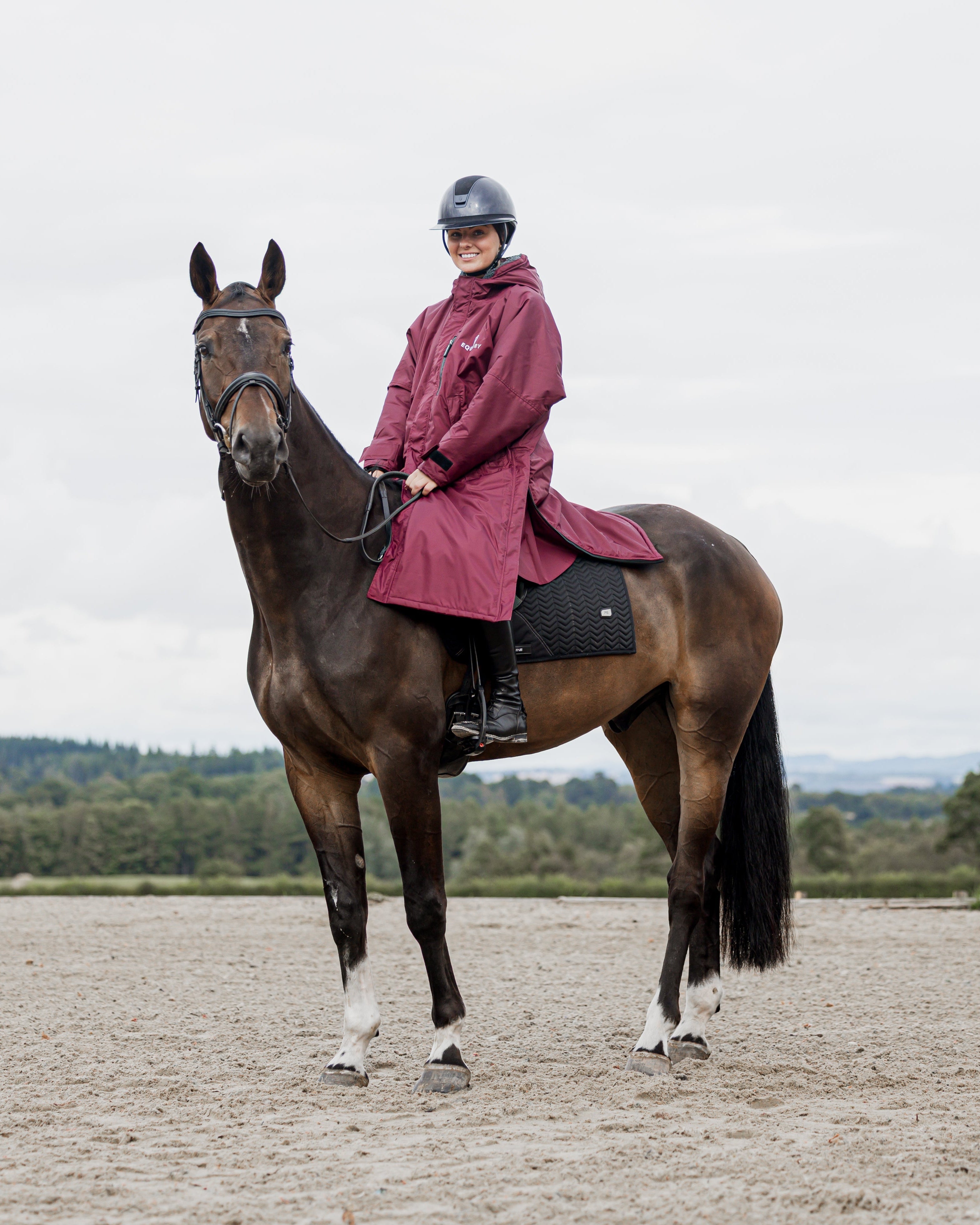 Equestrian Coat: Woman Riding Horse in Waterproof Equidry Plum Fleece Lined Coat for Horseback Riding