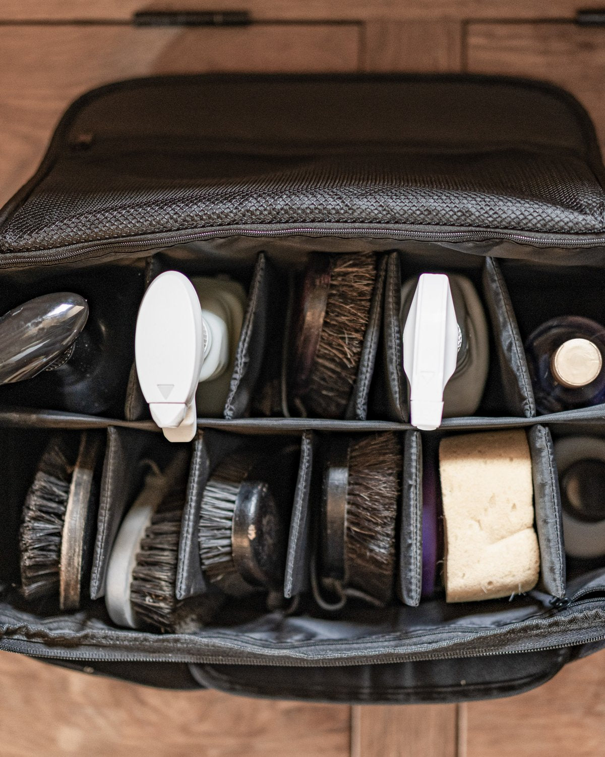 Woof Wear Grooming Bag: Black equine grooming organizer with brushes, bottles, and dividers.