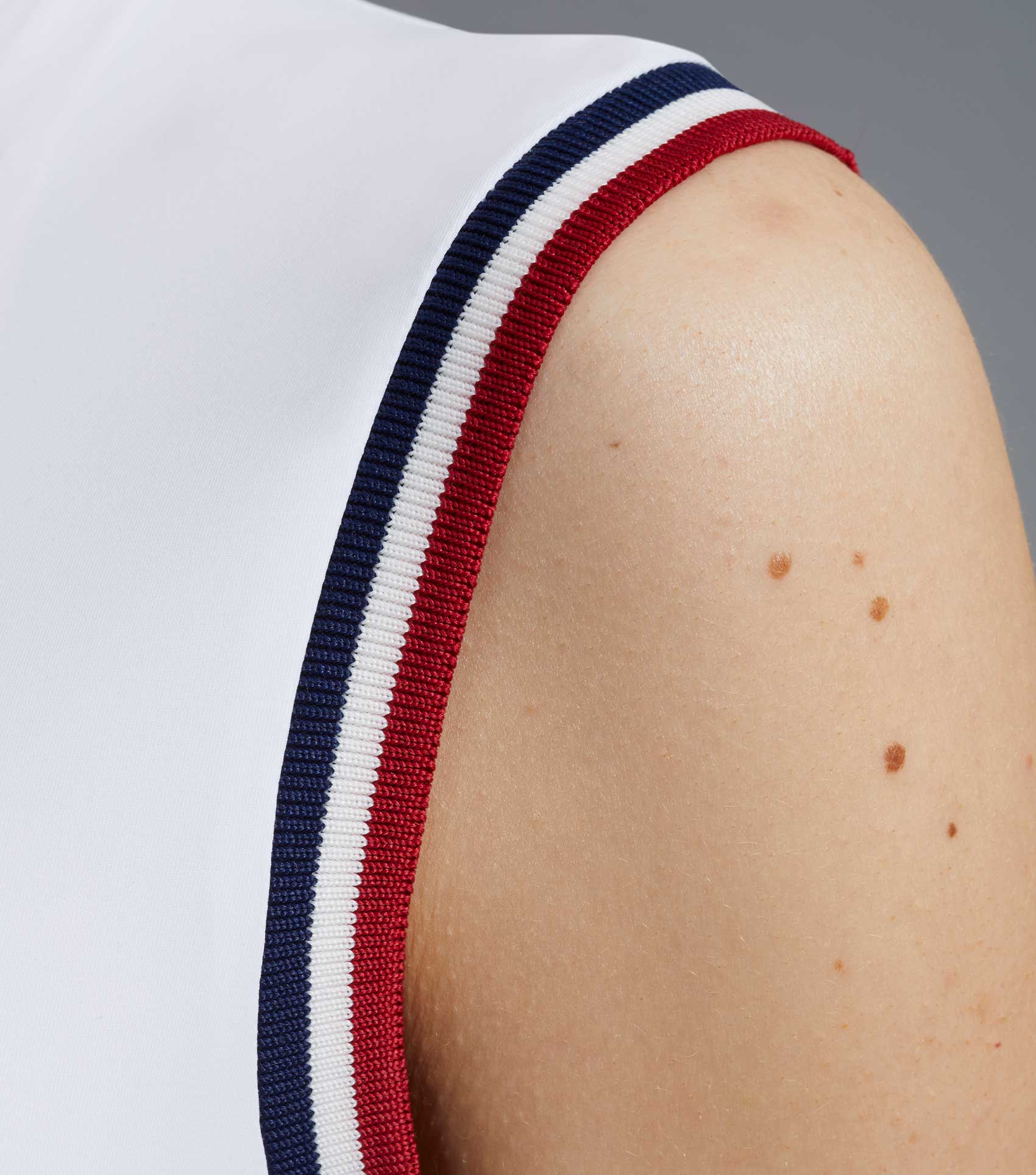 PREMIER EQUINE Alito White Sleeveless Riding Top: Ladies Equestrian Sportive Style with Red, White and Blue Trim.