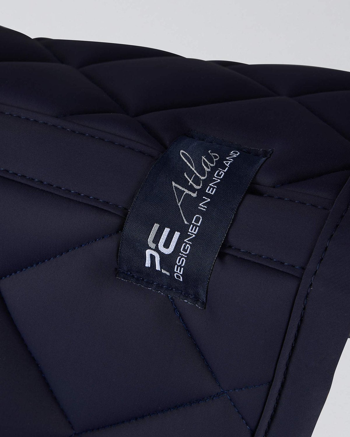 Premier Equine Atlas Close Contact Dressage Square - Navy saddle pad. Equiflair equestrian product detail.