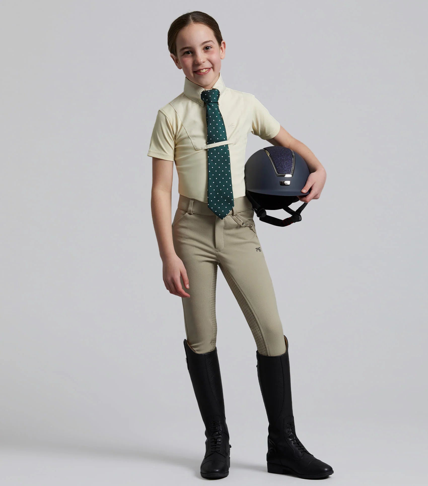 Girl Equestrian Outfit: Riding Breeches, Boots, and Helmet. Premier Equine Brand.