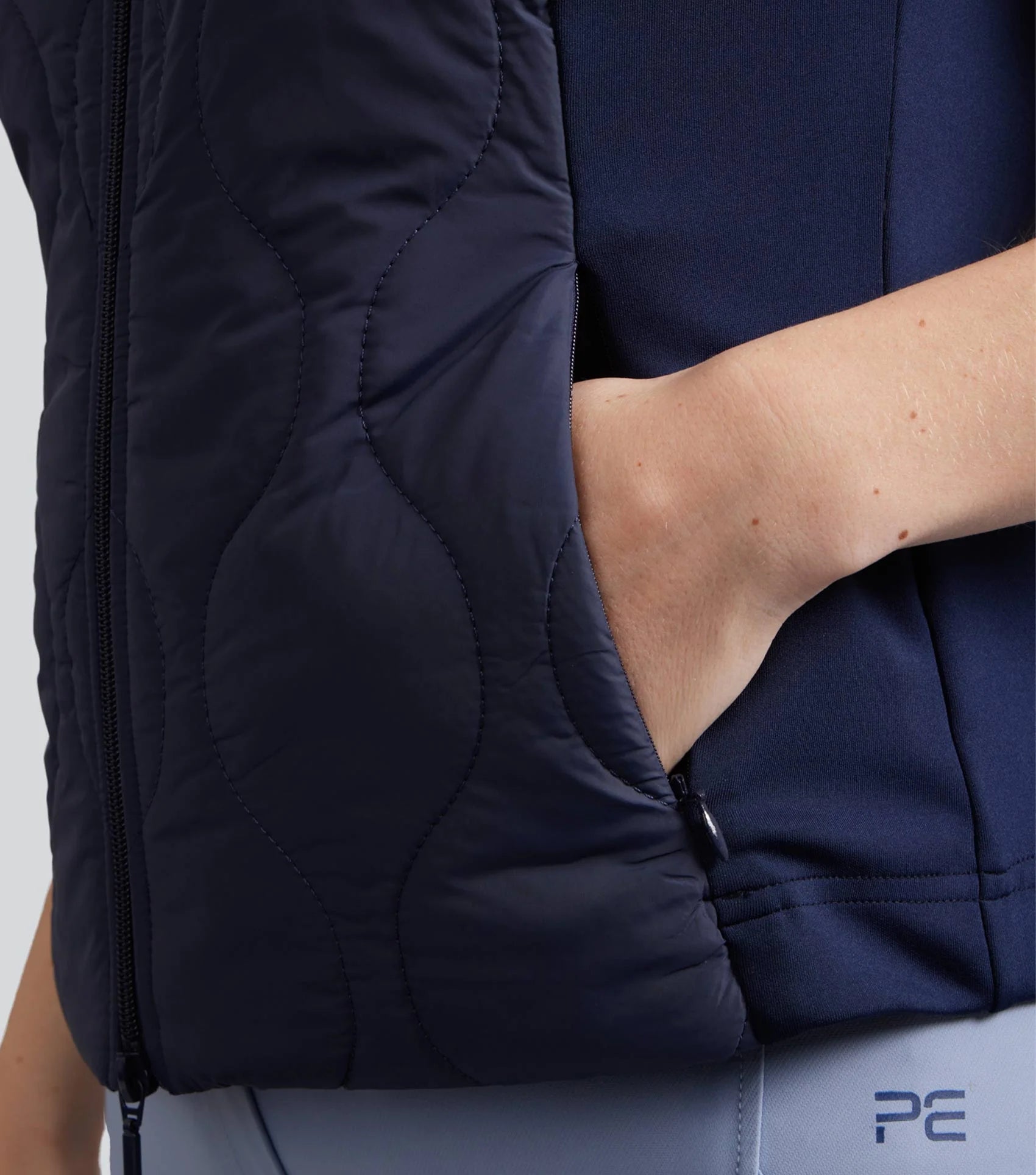 PREMIER EQUINE Campani Quilted Riding Gilet Navy: Woman's hand in pocket, windproof & water repellent equestrian vest