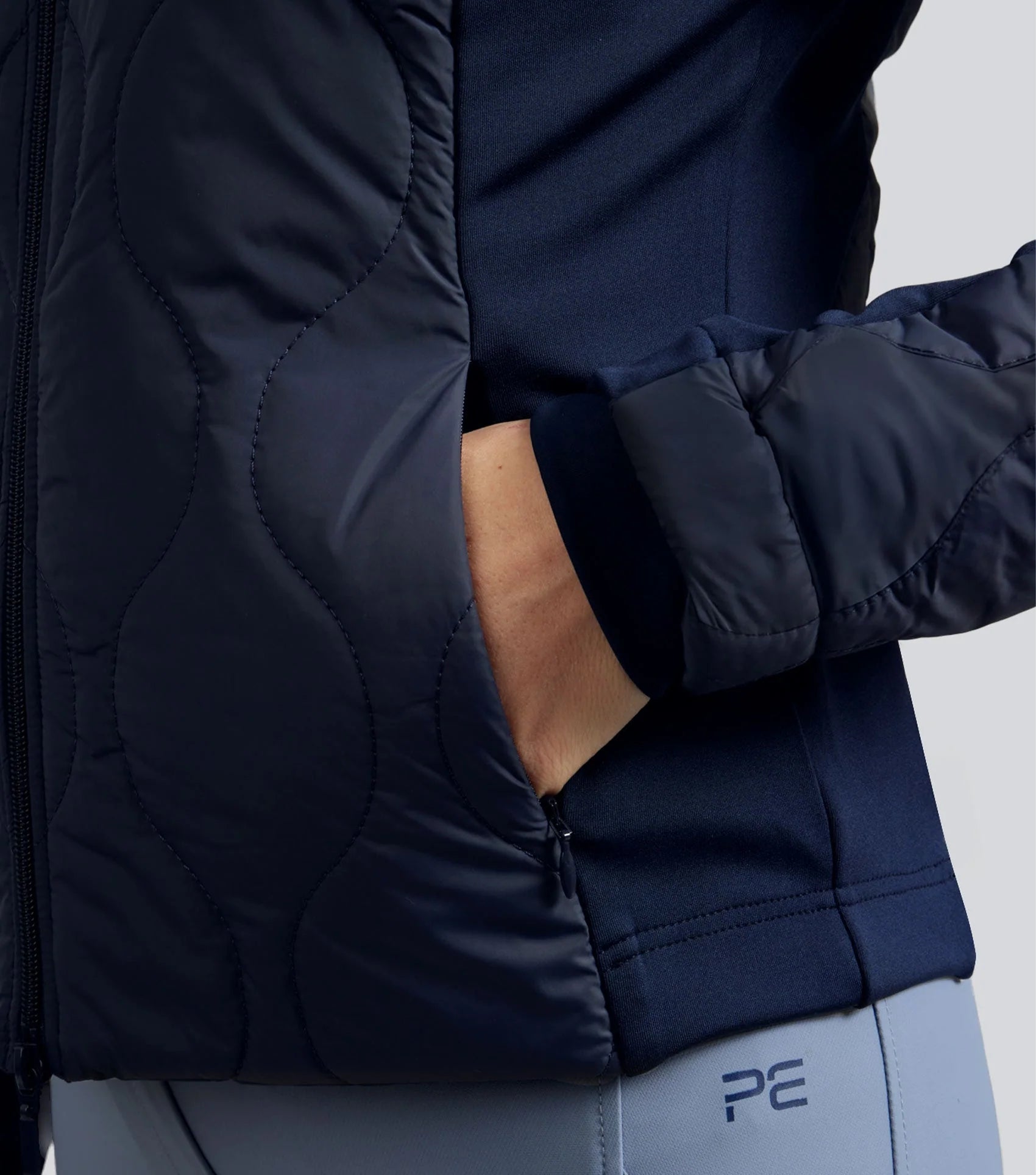 Premier Equine Campani Navy Quilted Riding Jacket: Close-up of pocket and quilted design, with visible PE logo.
