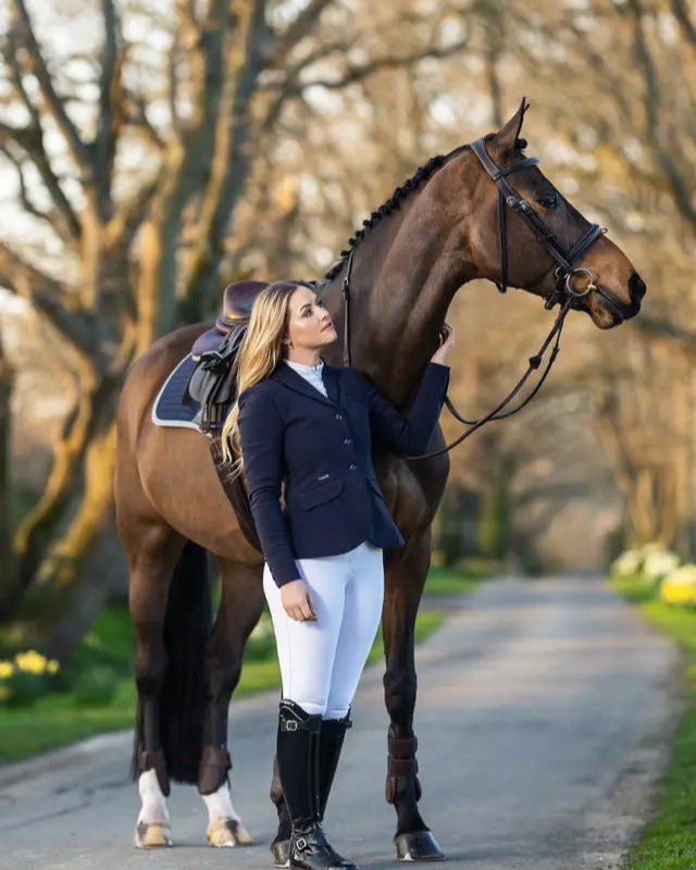 Equestrian elegance: LeMieux Dynamique Navy Show Jacket for competition riding. Horse and rider fashion.