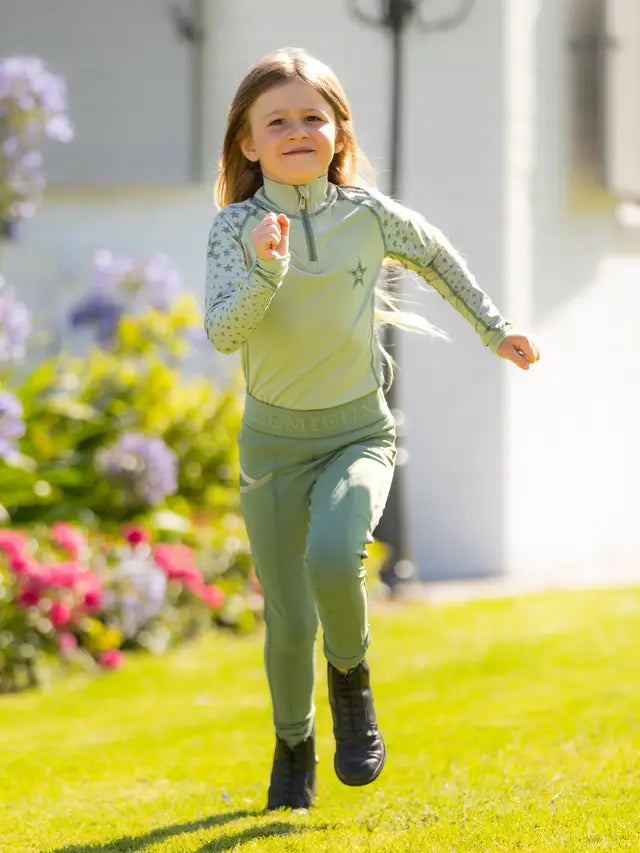 LeMieux Mini Riding Base Layer - Fern. Child's equestrian activewear top, long sleeve, UV50+ protection.