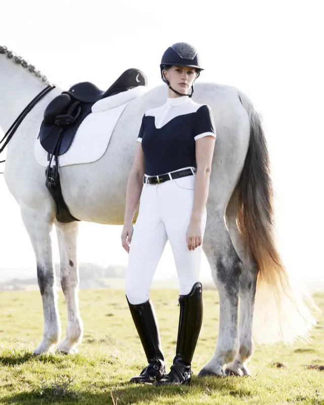 Equestrian Fashion: Woman in LEMIEUX Show Shirt, White Breeches, Riding Boots Posing with Horse
