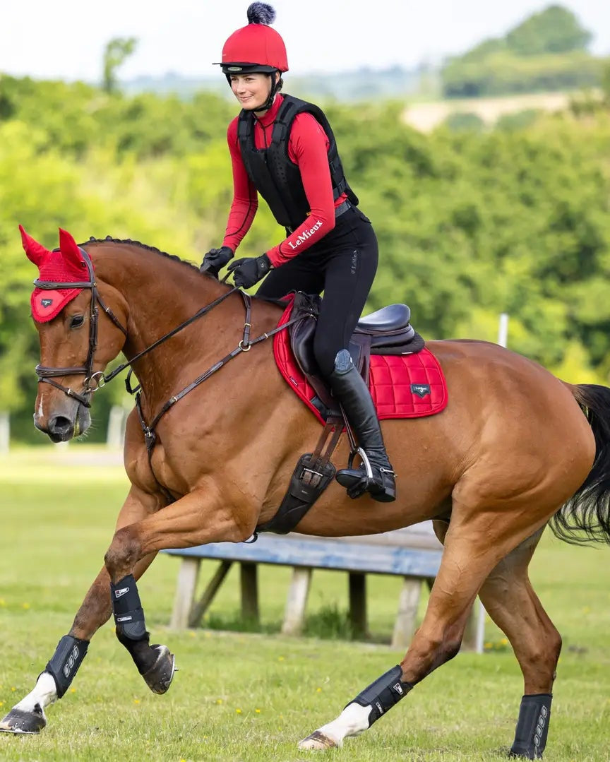 Equestrian Excellence: Woman Riding Horse with Lemieux Loire Saddle Pad in Red | Dressage, Equestrian Sport
