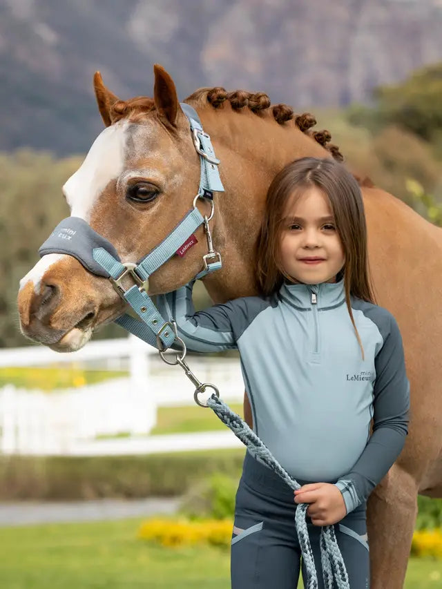 Girl with horse wearing LEMIEUX MINI BASE LAYER GLACIER from Equiflair - child riding apparel, equestrian fashion