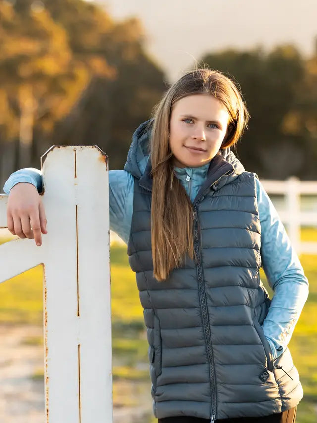 LeMieux Young Rider Milly Puffer Gilet - Petrol. Stylish girl in LeMieux vest outdoors, equestrian fashion.