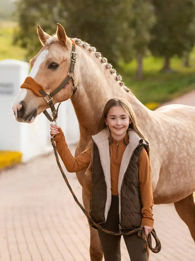Girl with Horse Wearing LeMieux Young Rider Eloise Reversible Winter Gilet - Alpine
