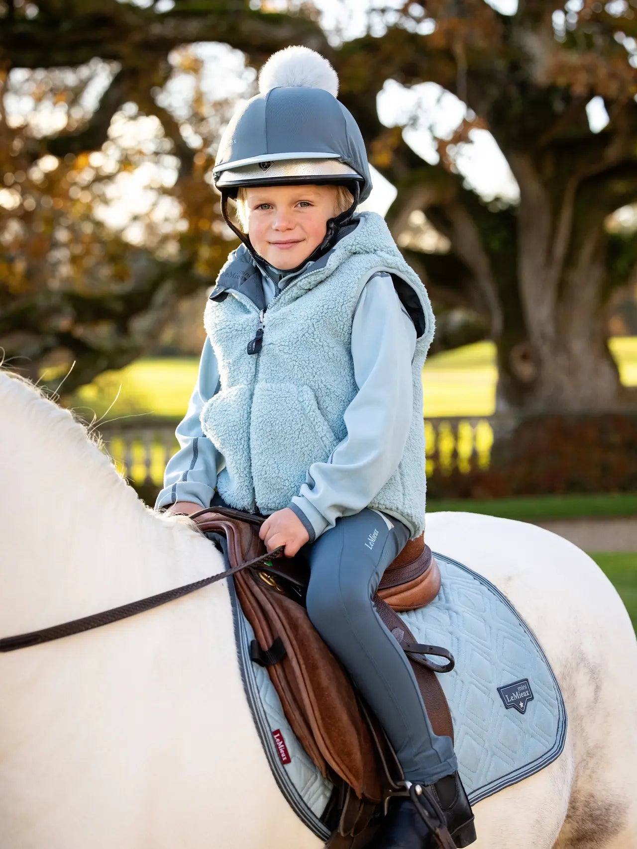 LEMEUX MINI ELSIE REVERSIBLE GILET in petrol on child horse rider. Kids equestrian wear.