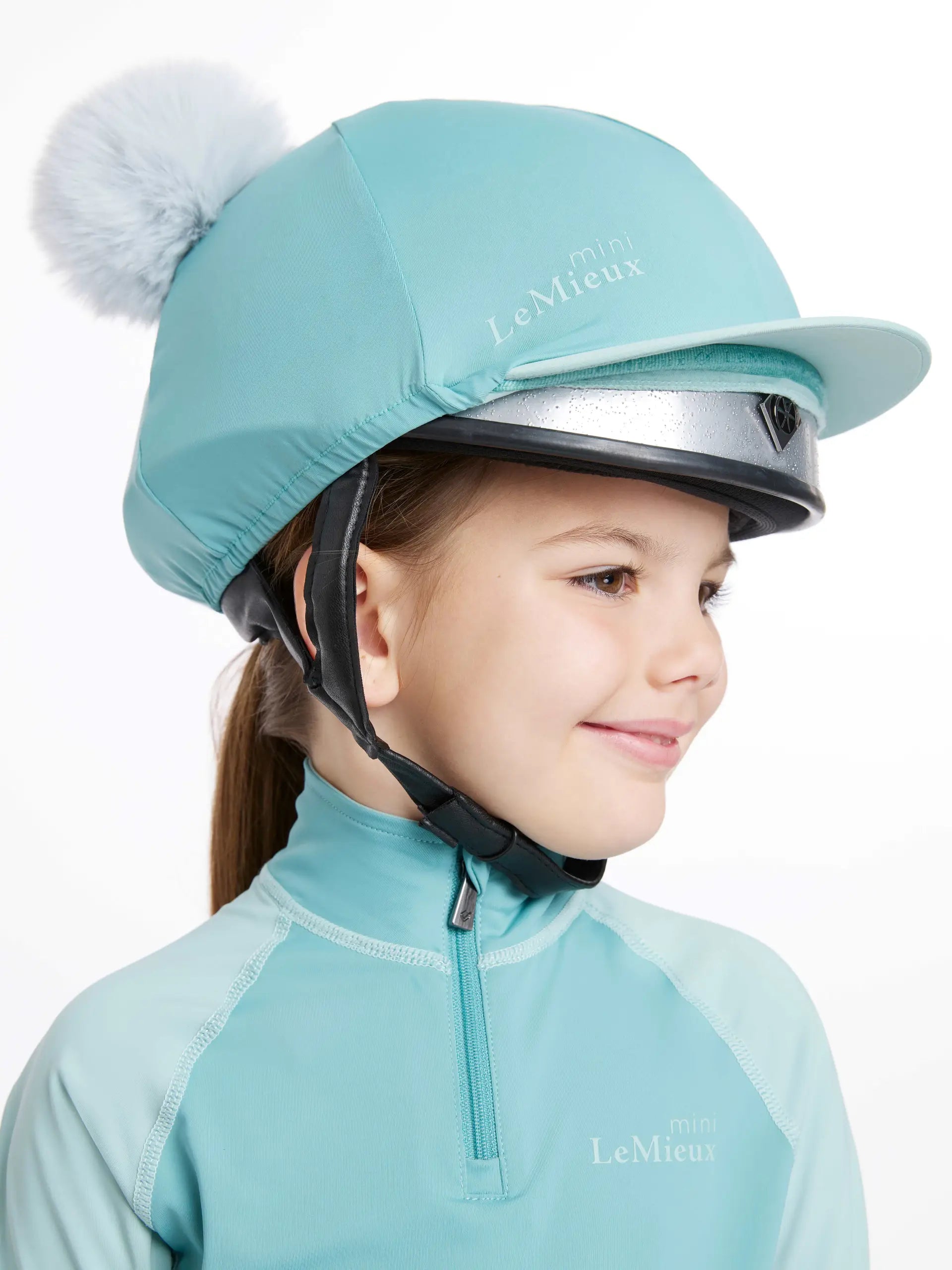 LEMIEUX Mini Double Pom Hat Silk Lagoon: Equestrian Riding Helmet for Kids. Blue Riding Hat with a double pom pom detail. Girls equestrian apparel.
