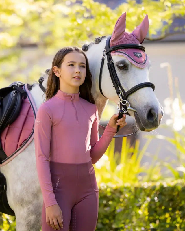Girl and horse wearing matching LeMieux Peony riding apparel. Equestrian fashion.