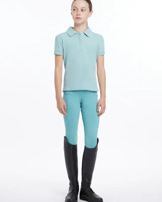 Girl in Aqua Equestrian Riding Attire: Polo Shirt, Jodhpurs & Boots