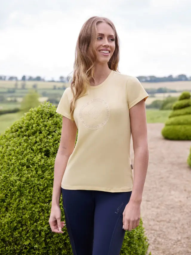 LEMIEUX CLASSIQUE T-SHIRT MIMOSA - Equiflair. Woman Wearing Yellow Lemieux Equestrian Top