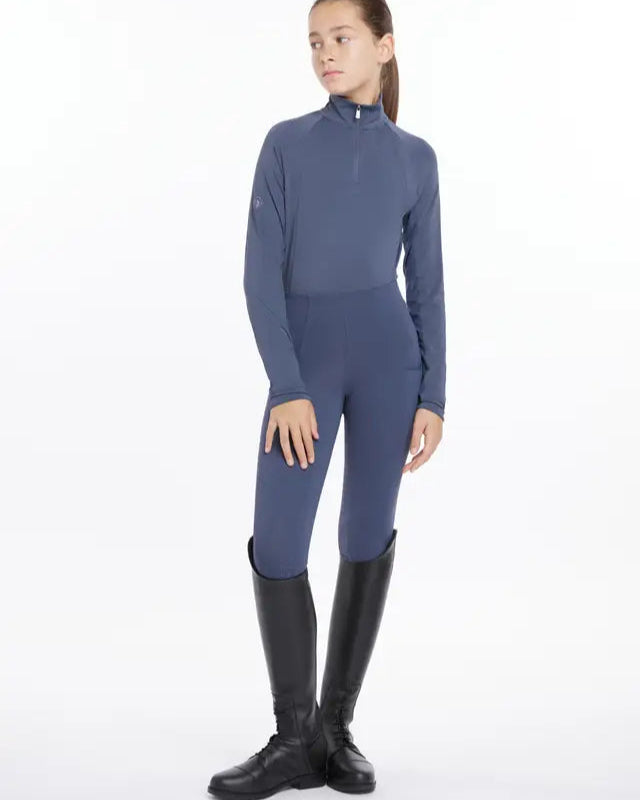 Young rider in Lemieux Dusk Blue Lightweight Base Layer, leggings & riding boots. Equestrian apparel by Equiflair. #equestrianstyle