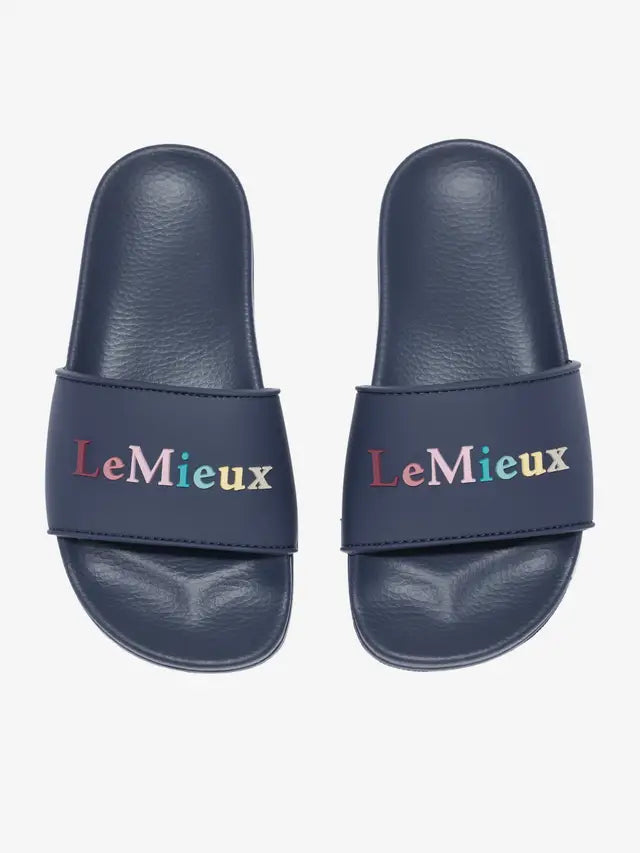 LeMieux Young Rider Sliders Dusk: Comfortable slip-on sandals for kids, featuring colorful logo branding and a supportive footbed.