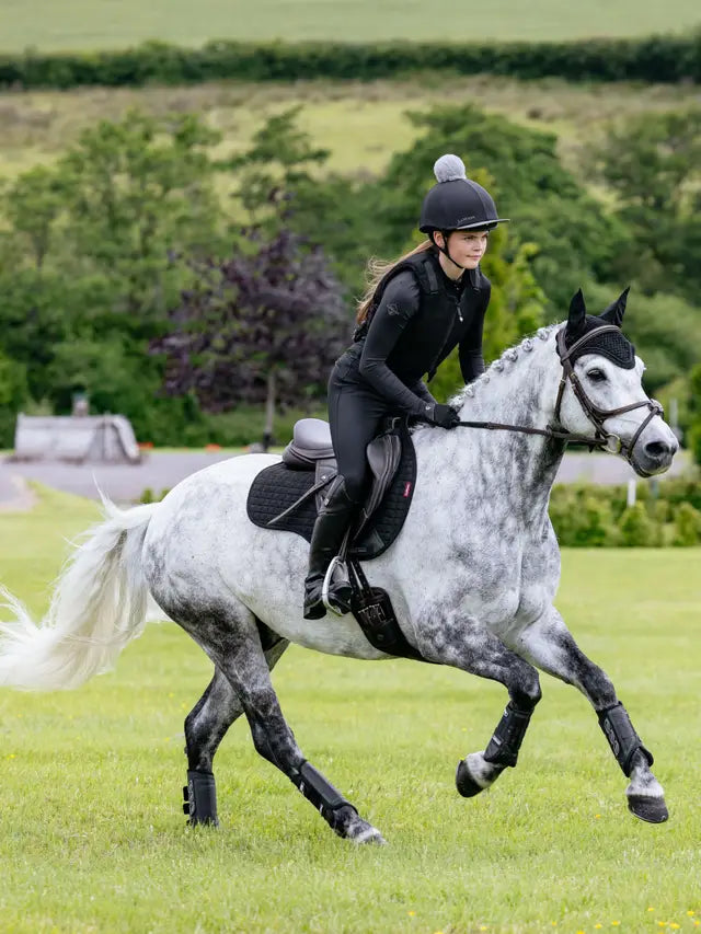 Equestrian Rider on Dapple Gray Horse Wearing LEMIEUX SUEDE GP SQUARE BLACK Saddle Pad from Equiflair, Black Gear Horseback Riding
