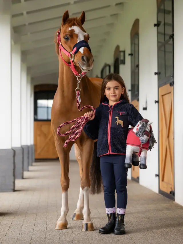 Girl with Pony: LeMieux Mini Teagan Fleece Navy Jacket, Riding Boots, & Toy Horse. Equestrian Style for Kids. Equiflair.