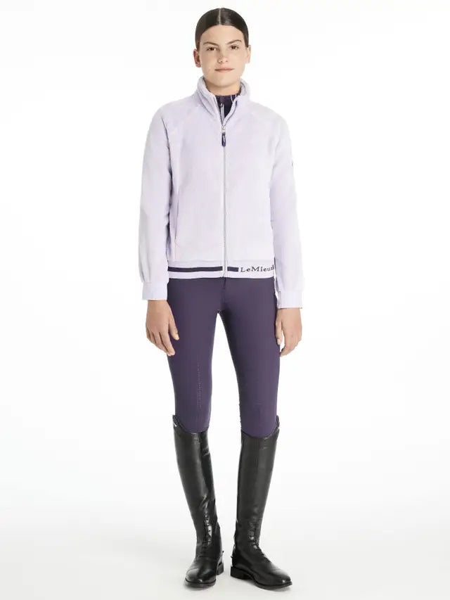 Young Rider Libby Fleece Lilac Jacket by LeMieux at Equiflair. Zip-through mid-layer, soft fleece, LeMieux branded…