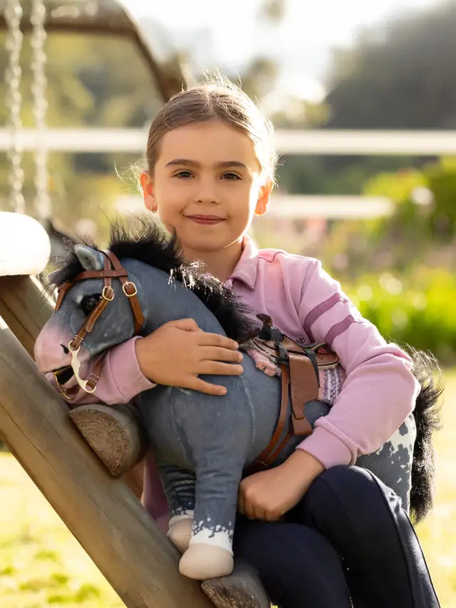 Child playing with LeMieux Toy Pony Comet Appaloosa horse toy