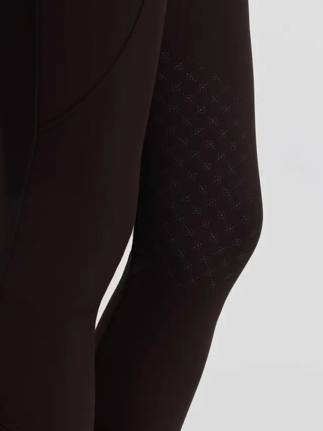 Brown LeMieux Brilliance equestrian breeches featuring detailed knee grip pattern close-up.