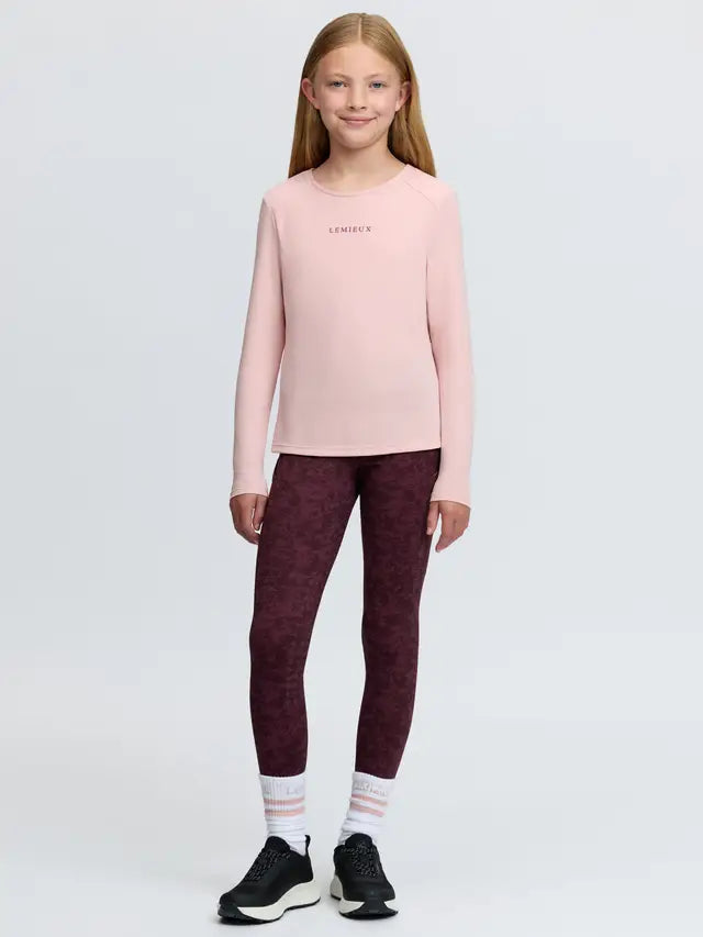 Young Rider's pink long-sleeved sports top with 'LeMieux' logo and patterned leggings.