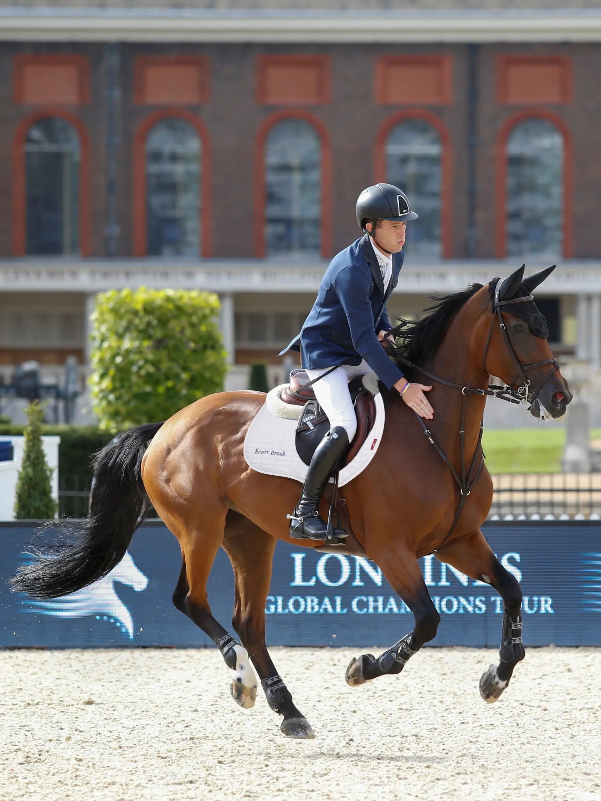 Scott Brash show jumping with horse, wearing LEMIEUX Suede Eurojump Square White saddle pad. Equestrian event image.