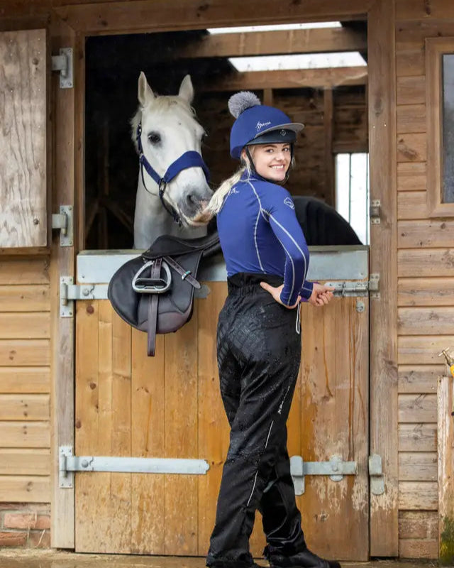 LeMieux Drytex Waterproof Trousers: Equestrian Girl with Horse in Stable at Equiflair Saddlery. Winter Riding Gear