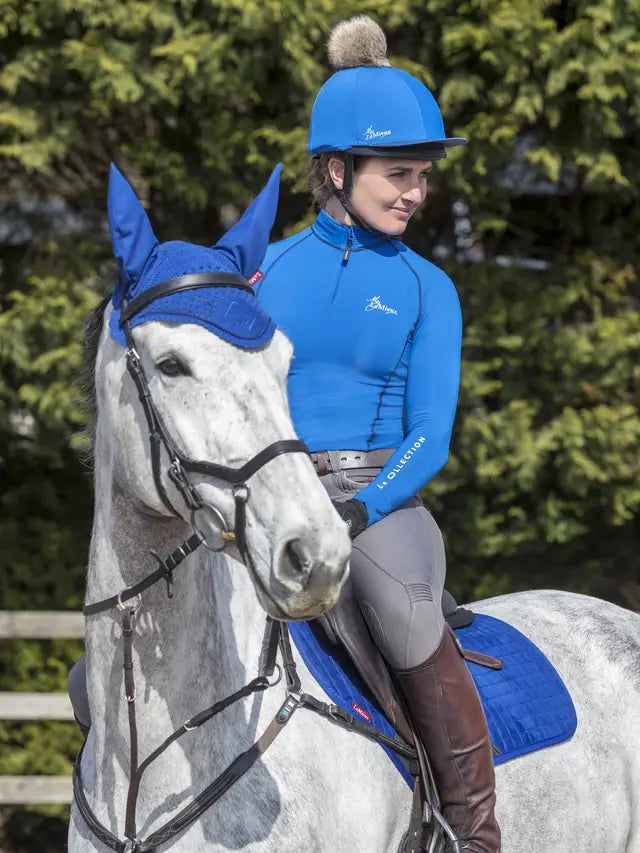 Equestrian Style: Woman on Horse with LeMieux Blue Hat & Ear Bonnet, Horse Riding Gear by LeMieux.