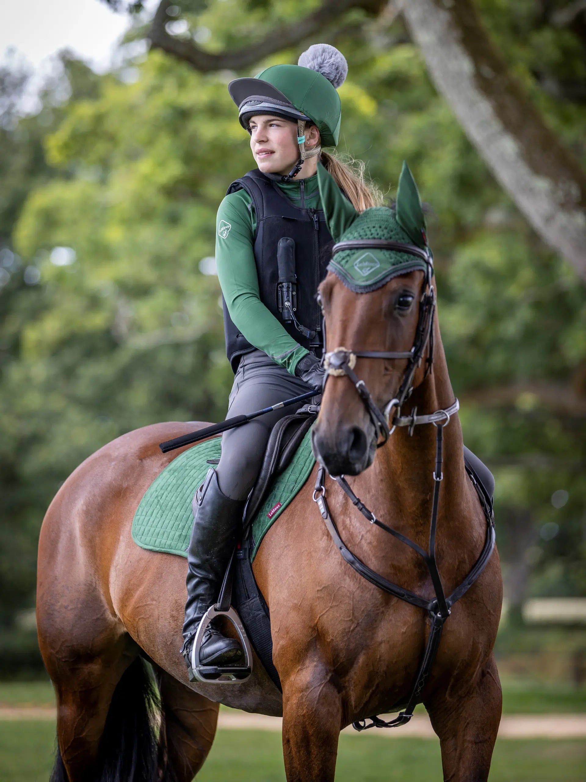 Equestrian Style: Girl Riding Chestnut Horse in Hunter Green Lemieux Set - Helmet, Pad & Bonnet