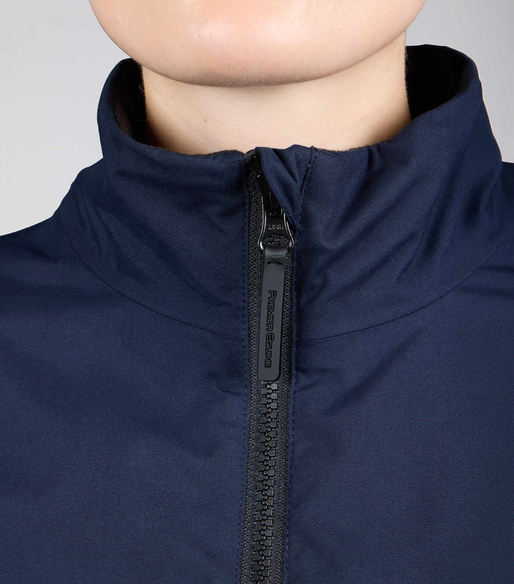 Close up: Premier Equine Navy Waterproof Riding Jacket. Equestrian Sportswear, Premier Equine Jacket, Navy Jacket.