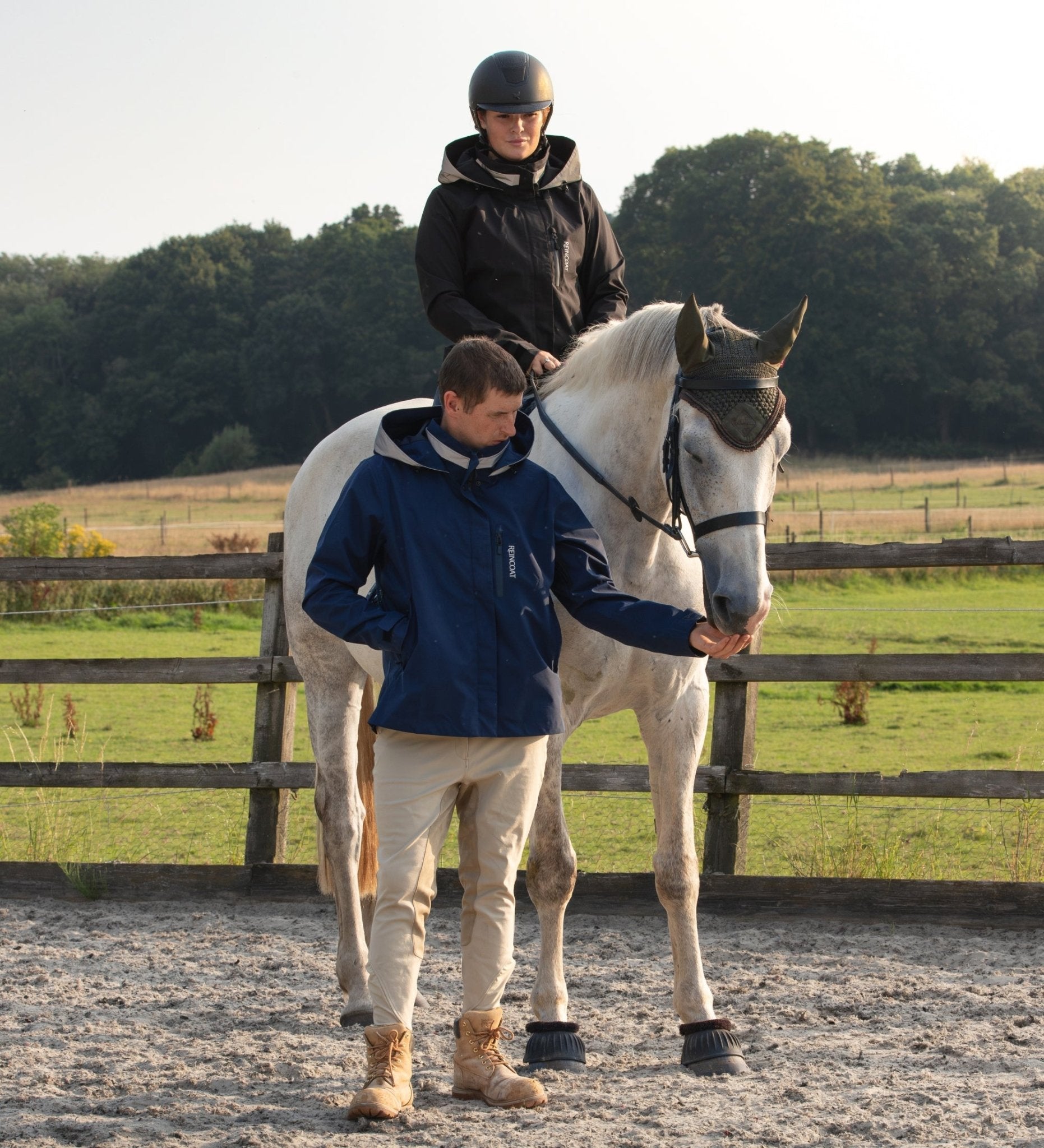 Horseback Riding with Reincoat Jacket: Man feeding horse, Woman riding. Equiflair.