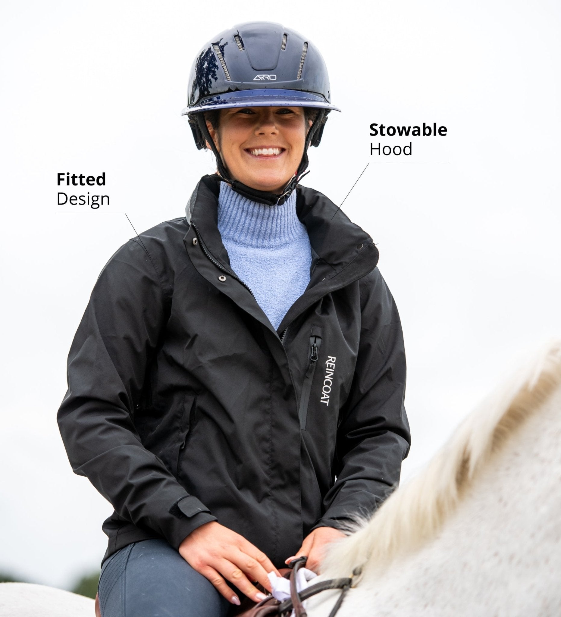 Reincoat Air Adult - Black waterproof equestrian riding jacket. Woman wearing helmet riding horse. - Medium