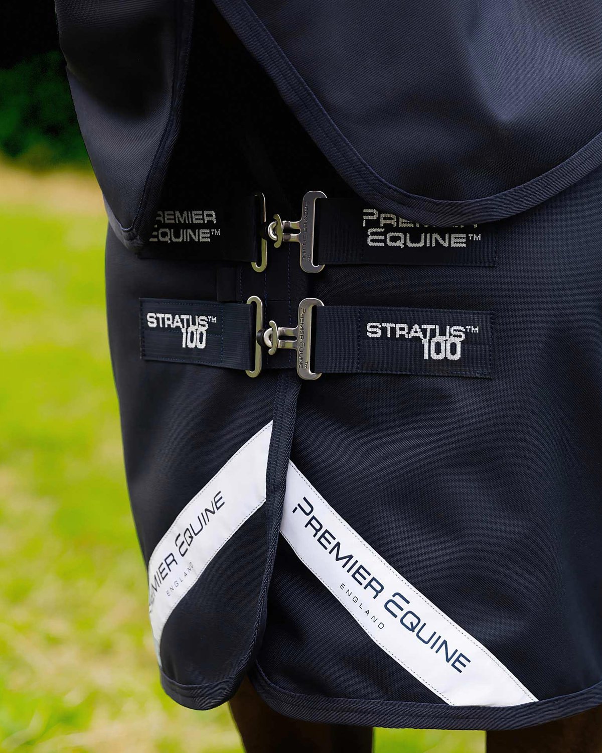 Premier Equine Stratus 100 Horse Rug: Close-up of buckles, branding, and waterproof design. Durable horse wear.