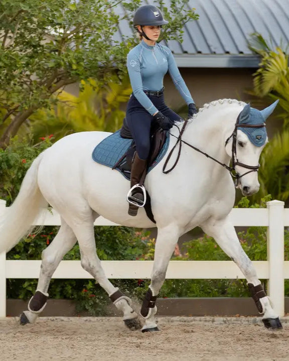 Equestrian: Dressage horse with rider wearing LEMIEUX Loire Classic Close Contact Square Ice Blue saddle pad. #Lemieux #Dressage #HorseRiding