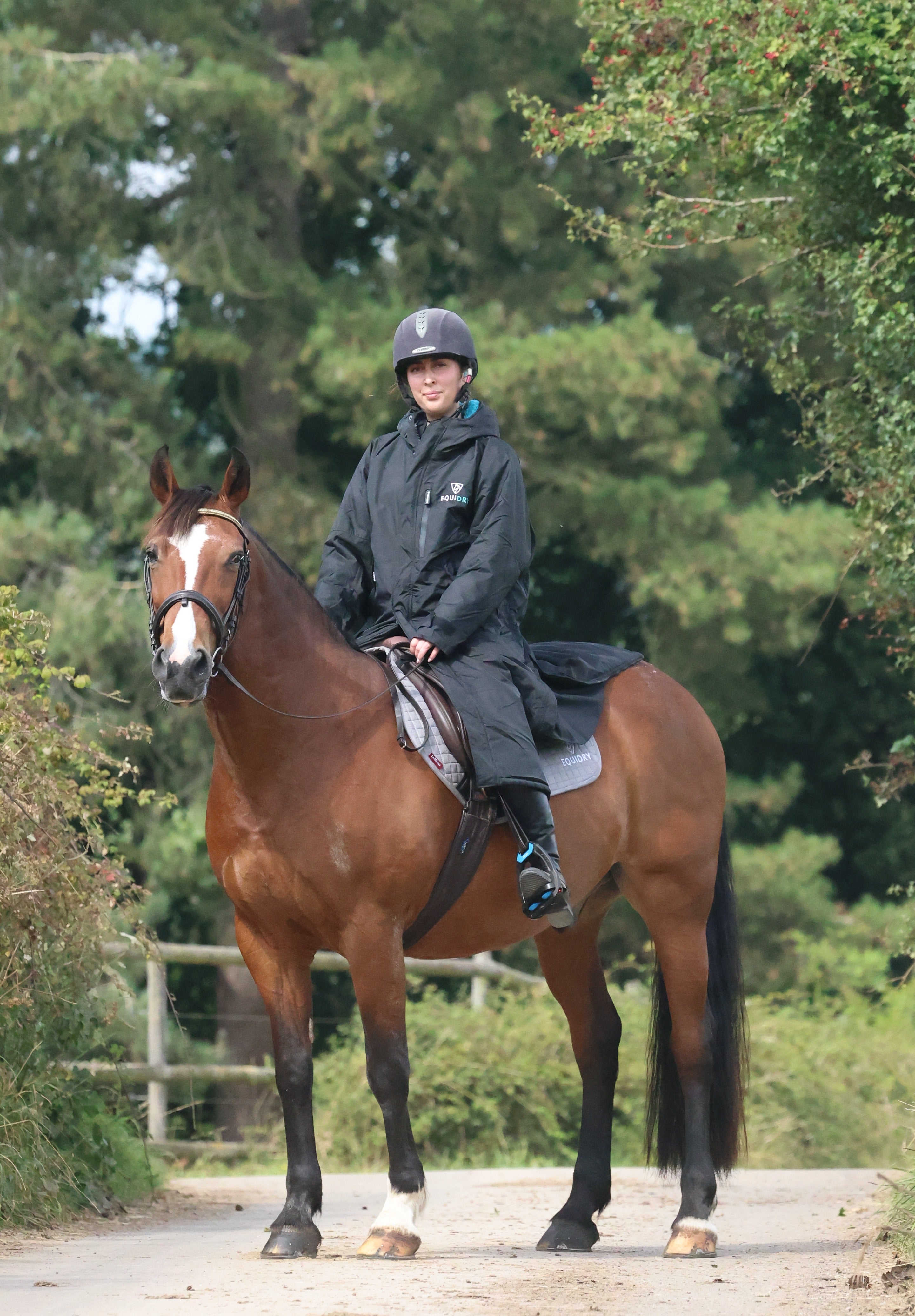 EQUIDRY Black Waterproof Horse Riding Coat: Woman on Horseback