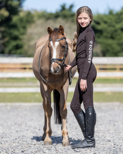 Girl with Horse in EQUIDRY Children's Riding Base Layer: Water Repellent Equestrian Outfit