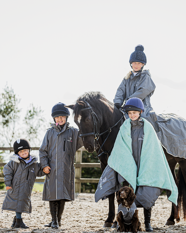 EQUIDRY waterproof horse riding raincoat thin fleece pro ride reflective in charcoal/pale pink children's grey family photo in arena