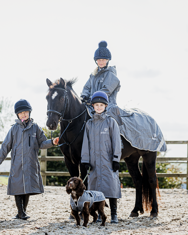 Children horse riding with Equidry waterproof coats & dog wearing Equidry coat from Equiflair