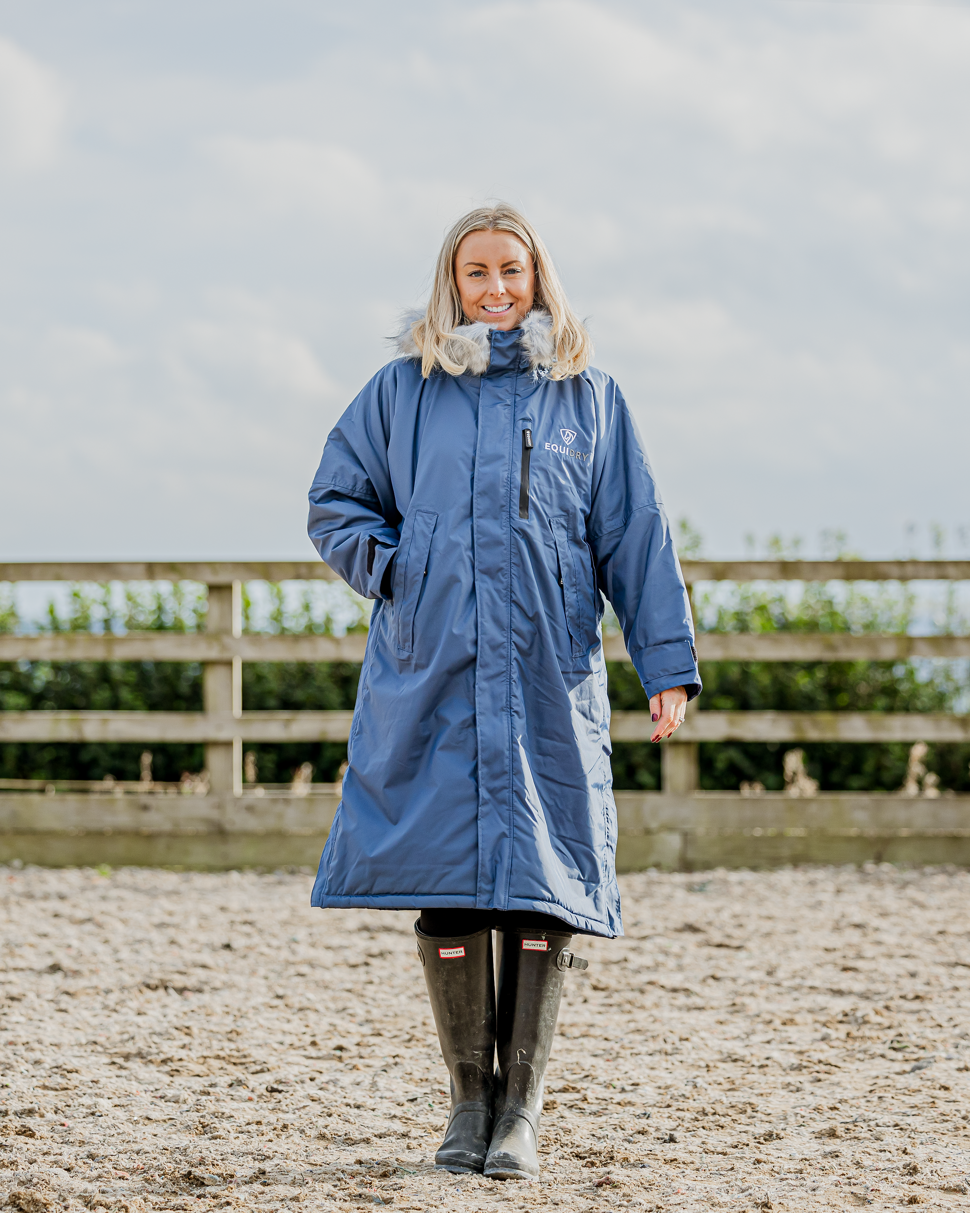 EQUIDRY Evolution Women's Steel Blue Fleece Riding Coat. Equiflair. Waterproof, Oversized. Woman wearing blue Equidry coat.