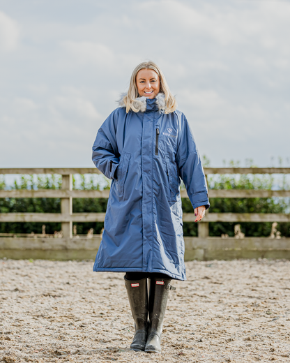 EQUIDRY Evolution Women's Steel Blue Fleece Riding Coat. Equiflair. Waterproof, Oversized. Woman wearing blue Equidry coat.