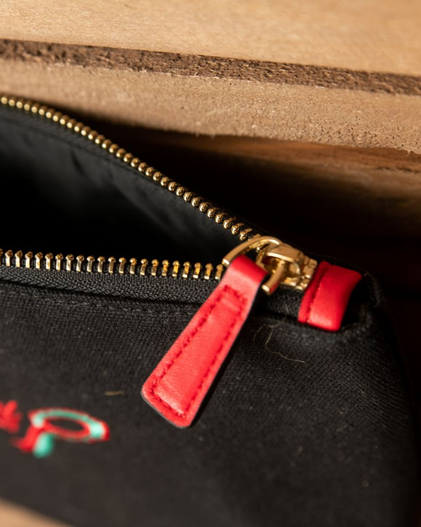 Equiflair smart grooming accessories pouch: black cotton, red leather tag, brass zip. Store hair accessories and makeup