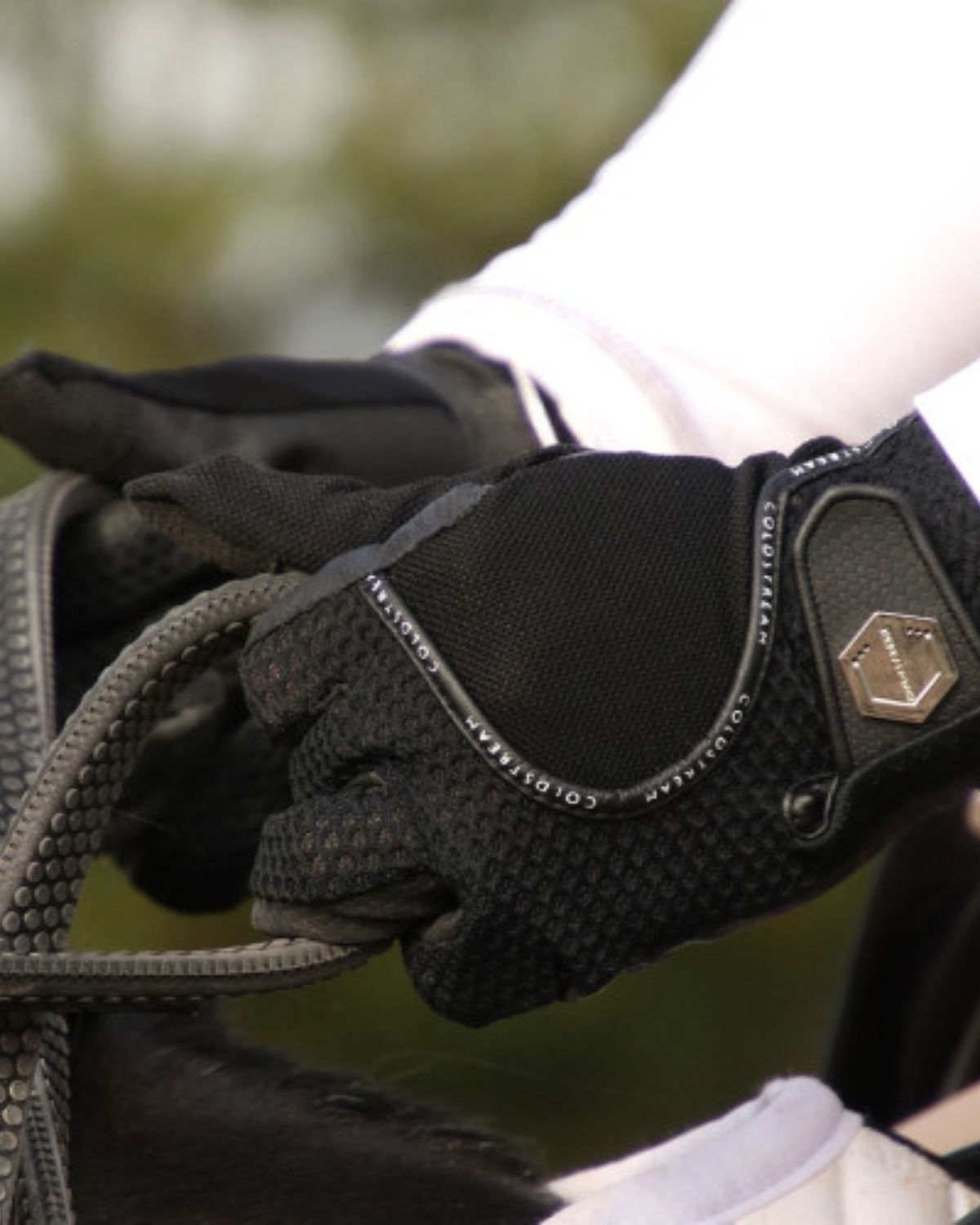 COLDSTREAM Black Mesh Riding Gloves: Summer Equestrian Gear for Grip & Comfort. Horse Rider Holding Reins.