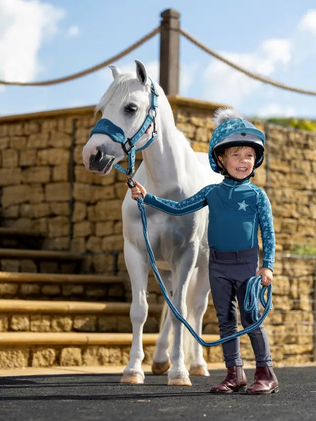 Child in LeMieux Riding Gear with Pony. Mini Base Layer Marine. Equiflair