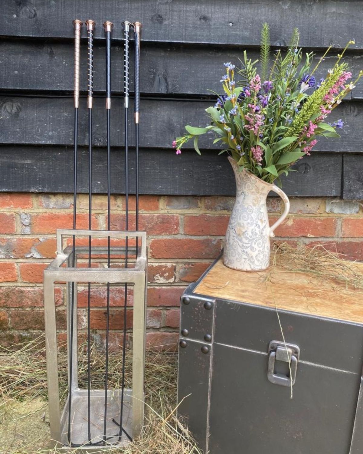 KM Elite dressage whips: black leather grip, rose gold cap, equestrian riding crops, flower vase